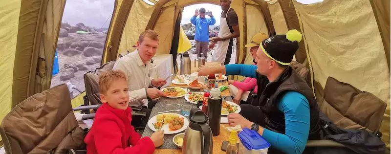 Having dinner with Team Kilimanjaro while climbing Kilimanjaro